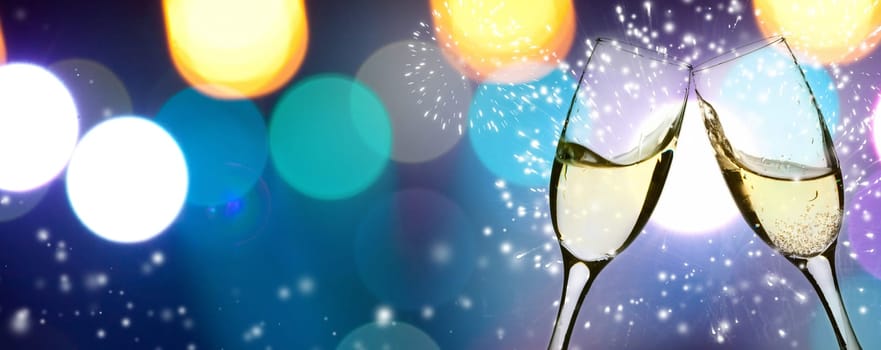 Two glasses of champagne with colorful lights in the background
