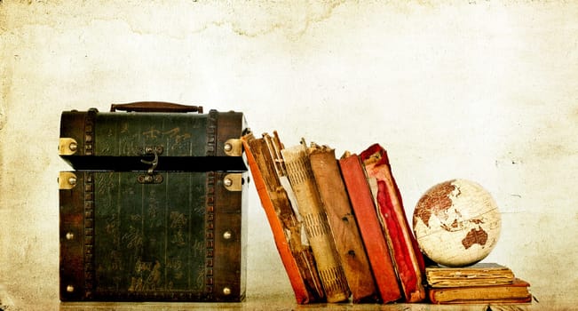 Vintage photo of old books, treasure box and Earth globe
