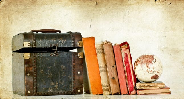 Vintage photo of old books, treasure box and Earth globe