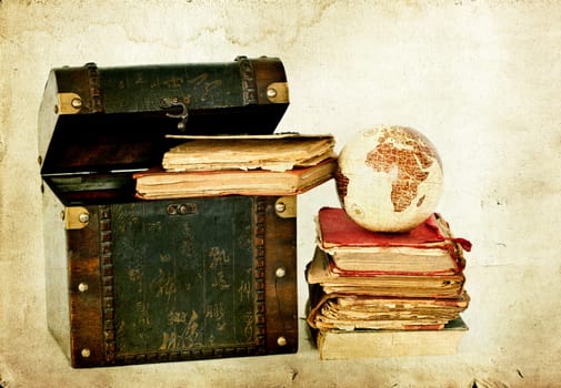 Vintage photo of old books, treasure box and Earth globe