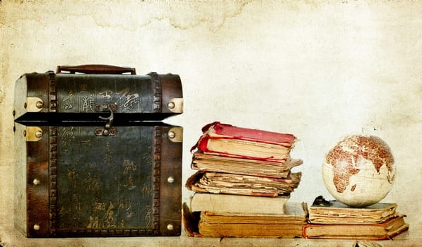 Vintage photo of old books, treasure box and Earth globe