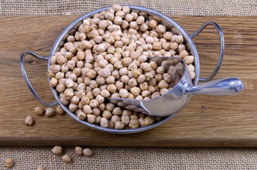 Bowl of dried chickpeas on a wooden board