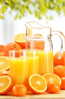 Composition with glasses of orange juice and fruits