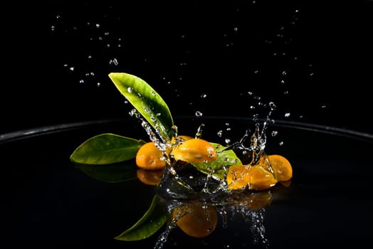 citrus fruit falling in water drops splashing everywhere. Concept of freshness and purity.