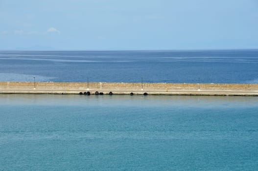 Jetty wall sea and sky horizon abstract background.