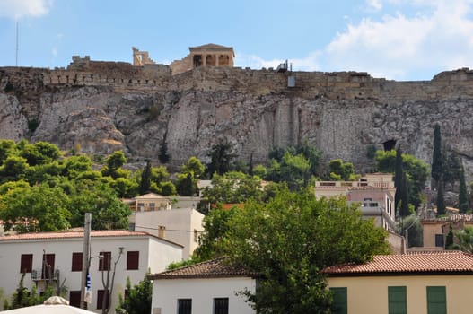 Houses at Plaka neighborhood and the Acropolis walls, Athens, Greece.