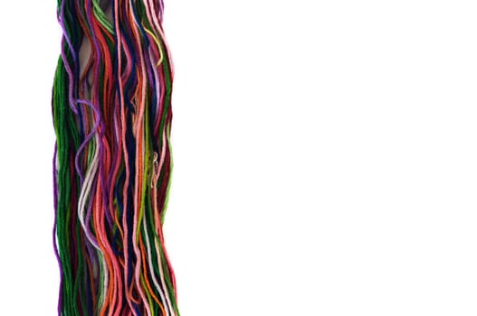 Multicolor sewing threads macro on white background.