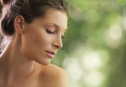Portrait close up of young beautiful woman, on green background summer nature.