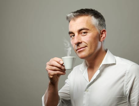 Handsome mature man enjoying a hot drink