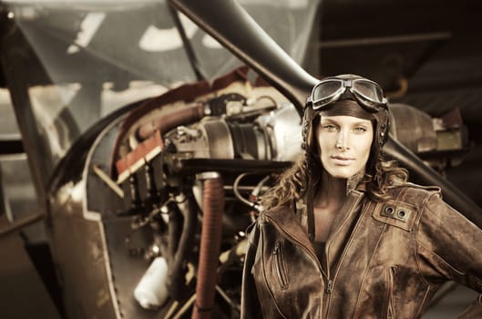 Portrait of young woman airplane pilot. Airplane on the background