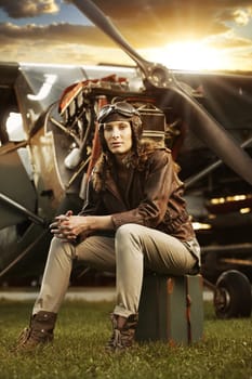 Portrait of young woman airplane pilot. Airplane on the background