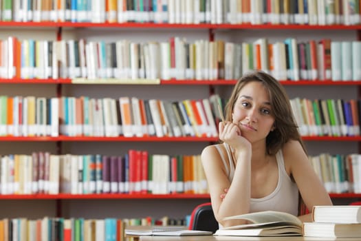 Portrait of a young student in a library