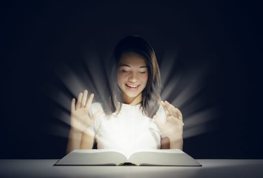 Young girl open a magic book