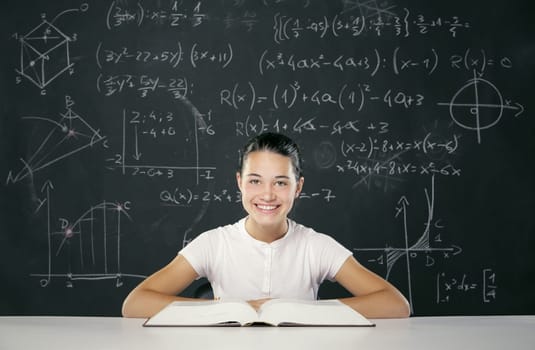 Student sitting in front of a blackboard full of math formulas