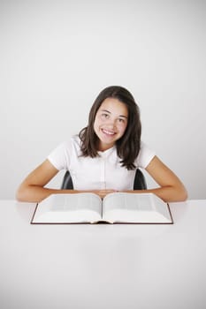 Young girl with book, smiling