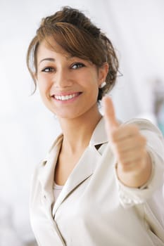 Happy smiling businesswoman with thumbs up gesture