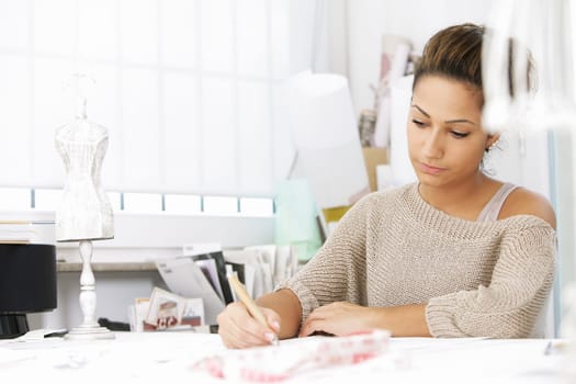 Fashion designer is drawing a fashion model