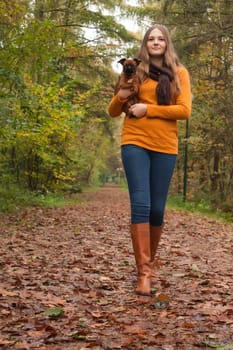 Young teenage girl is having a nice time in the cold november