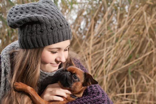 Young teenage girl is having a nice time in the cold november
