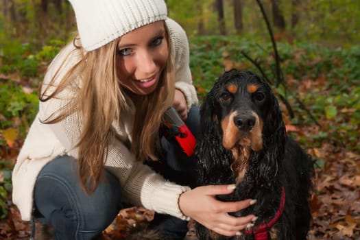 Girl and her dog are having a wet time in the rain