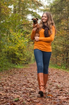 Young teenage girl is having a nice time in the cold november