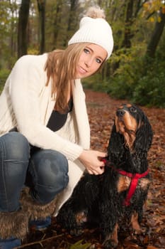Girl and her dog are having a wet time in the rain