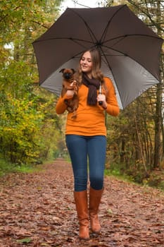 Young teenage girl is having a nice time in the cold november