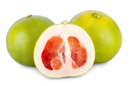 Two whole and one half pomelo fruit isolated against a white background