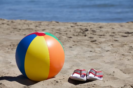 Water polo and flip-flops - flip flops lie on the beach in the background is the sea
