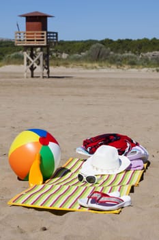 Beautiful beach with beach accessories and a tower in the background
