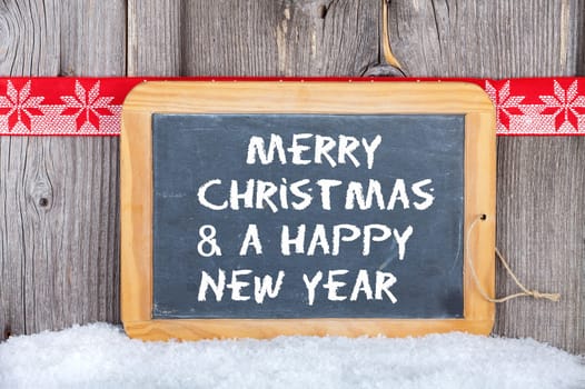 Christmas and a Happy New Year Greetings on old Slate Chalkboard
