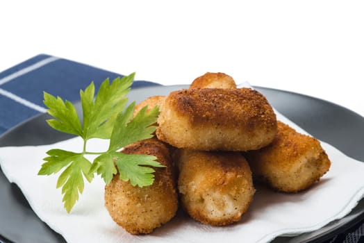 A plate with homemade croquettes decorated with parsley