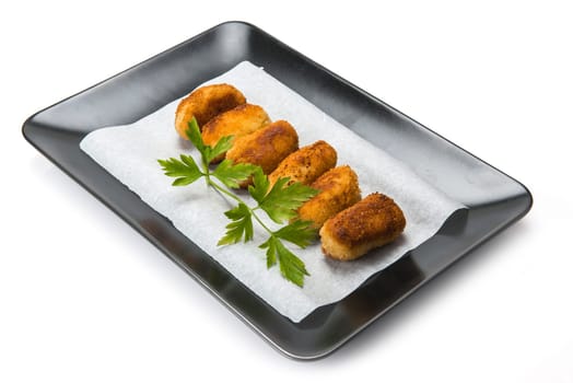 A plate with homemade croquettes decorated with parsley