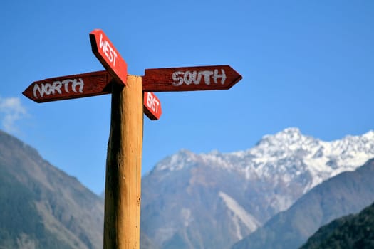 A signpost points to the south,north,west and east.