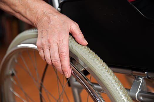 Old hand on the wheelchair