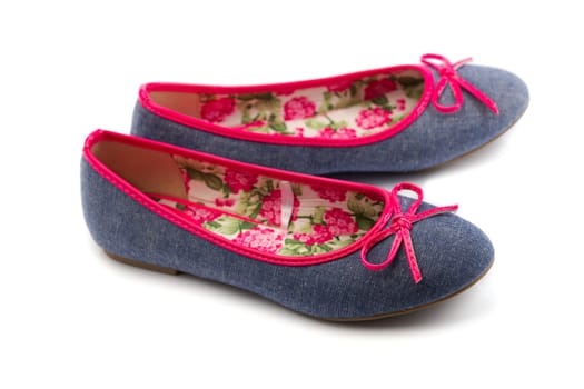 Pair of denim ballerinas. Isolate on white.