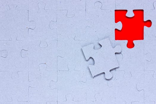 Blue puzzle with missing piece in a red color