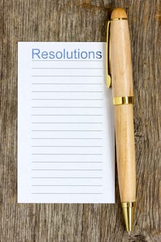 Wooden pen and notepad list for New Year's resolutions