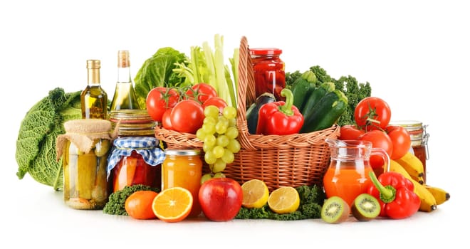 Composition with variety organic vegetables and fruits in wicker basket isolated on white