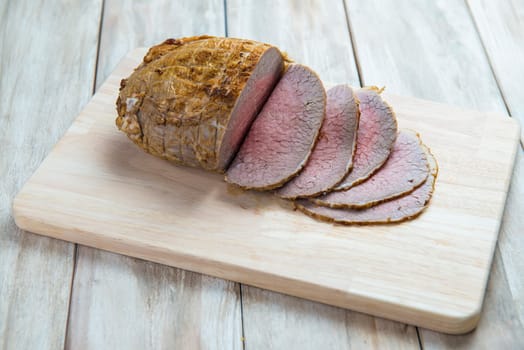 Sliced roast beef on the cutting board