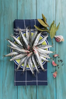 Fresh raw sardines on the table of the kitchen to be cooked.