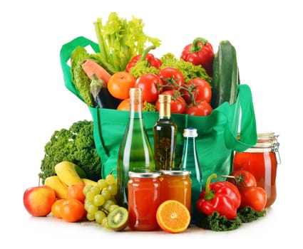 Green shopping bag with variety of fresh organic vegetables isolated on white