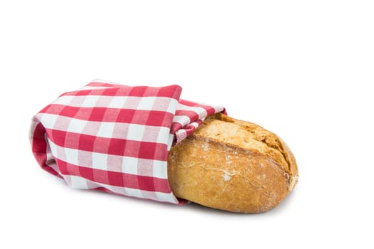 wheat bread covered wit a dishcloth and isolated on a white background