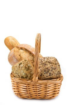 Still life about a basket with a large bread assortment isolated over a white background