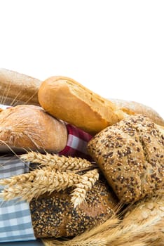 Bread assortment decorated with cereal ears and isolated over a white background