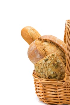 Still life about a basket with a large bread assortment isolated over a white background