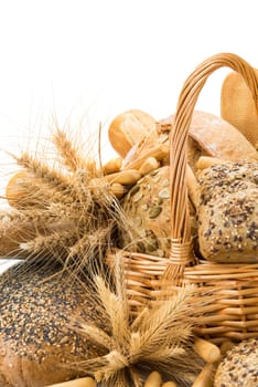 Still life about a basket with a large bread assortment isolated over a white background