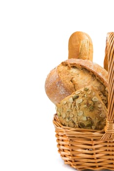 Still life about a basket with a large bread assortment isolated over a white background