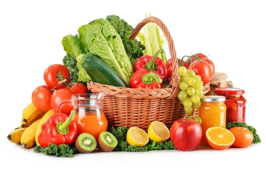 Composition with variety organic vegetables and fruits in wicker basket isolated on white