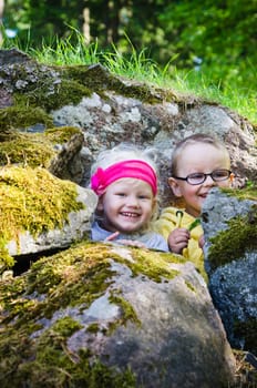 Young children, the boy with the girl hid among the rocks